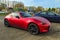 Mazda MX-5 red roadster car with two doors parked