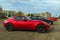 Mazda MX-5 small modern red roadster car with two doors parked