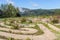 Maze concrete pathway of a labyrinth on the edge of misty valley