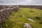 Maze of traditional dry stone walls and green fields. Landscape of Inishmore Aran islands, county Galway, Ireland. Dramatic sky in