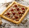 Mazurek pastry, traditional Polish Easter cake made of shortcrust pastry,  fudge caramel cream, candied fruit and almonds, closeup