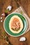 Mazurek, Polish Easter sweet made from shortcrust pastry in the shape of an egg with Easter decoration on a green plate on a