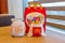 Mcdonalds happy meal box with Coca-Cola, french fries and cheeseburger on wooden table.