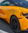 McLaren 720S supercar parked on a street. Orange supercar on the street of a city. Back view