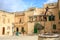 Mdina, Malta. Well at Misrah Mesquita square and traditional facade buildings background.