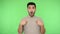 This is me? Brunette man pointing himself and looking shocked, pleasantly surprised. green background, chroma key