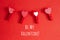 Me Ny Valentine. Holiday card with greeting text. Four cute little small clothespins with pattern hearts on red background.