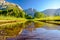 Meadow with flooded boardwalk and Yosemite Falls