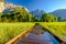 Meadow with flooded boardwalk and Yosemite Falls