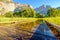 Meadow with flooded boardwalk and Yosemite Falls