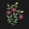 Meadow flower embroidered with pink, yellow and green stitches on black background. Elegant embroidery design with