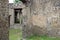 Meadow green grass under ancient ruined stone walls of Italian Roman Pompei