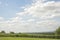 Meadow landskape, green valley and blue sky with white clouds in England
