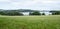 Meadow with Lipno water reservoir and hills on the background