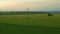 Meadow and power distribution lines at sunset in spring