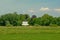 Meadows in the flemish countryside with a fancy mansion in beween trees ehind