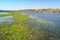 Meadows and pastures in hilly valley flooded with a spring river stream. Flower island islet in the middle of the water