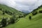 Meadows and rustic stone cabins in beautiful green valley