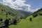 Meadows and rustic stone cabins in beautiful green valley