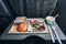 meal Economy Class. Airlines. for food on the plane. to feed the passengers. food set close-up top view. sausage with salad and