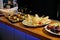 Meal. Festive buffet table for guests. Assortment of cold cuts,canapes on wooden skewers, festive snacks with fruits and