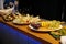 Meal. Festive buffet table for guests. Assortment of cold cuts,canapes on wooden skewers, festive snacks with fruits and