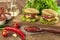 Meal, food. Two hamburger with cutlet grilled, lettuce, tomato, cheese, cucumber on a light wooden background