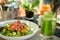 A meal of Mango and Ahi Tuna poke salad and frech green juice