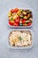 Meal prep containers with quinoa, grilled and fresh vegetables and chicken