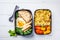 Meal prep containers with rice with chicken, baked vegetables, e