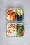 Meal prep containers with salmon, rice, green salad and pancakes, apple, blueberry