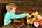 Meal time. Little child and teddy bear have meal together. Boy feed toy friend with healthy meal. Eat a healthy meal to