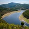 Meander of Melero surrounded by mountains on a day with blue sky, Riomalo de Abajo, CÃ¡ceres, Spain