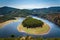 Meander of Melero surrounded by mountains on a day with blue sky, Riomalo de Abajo, CÃ¡ceres, Spain