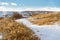 Meandering path through dry grassland in winter