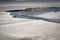 Meandering river flowing during low tide, waste landscape