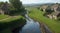 A meandering stream cutting through a village, providing water for the fields