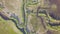 Meanders of the river and stream. Forest vegetation. Aerial image in the USA. Panoramic vertical from the top to the bottom.