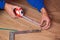 Measure board laminate tape measure,men`s hands measure the length of the floorboard, laminate the floor