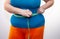 Measure the waist with a centimeter tape. Big size. The problem of excess weight. Full belly and folds. Hands of a woman dieting.