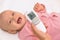 Measuring baby\'s temperature with contactless thermometer