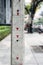 Measuring concrete pole with meter indication on footpath along