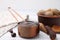 Measuring cup with tasty tamarind sauce and fresh pods on white wooden table