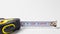 Measuring roulette yellow black on a white background banner with space for text. A construction tool tape measure
