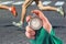 Measuring the running speed of an athlete using a mechanical stopwatch. hand with a stopwatch on the background of the legs of a