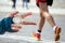 Measuring the running speed of an athlete using a mechanical stopwatch. hand with a stopwatch on the background of the legs of a