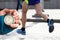 Measuring the running speed of an athlete using a mechanical stopwatch. hand with a stopwatch on the background of the legs of a