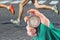 Measuring the running speed of an athlete using a mechanical stopwatch. hand with a stopwatch on the background of the legs of a