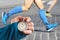 Measuring the running speed of an athlete using a mechanical stopwatch. hand with a stopwatch on the background of the legs of a