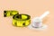 Measuring spoon with creatine, whey or casein, whey supplements, with tape measure beside, copyspace